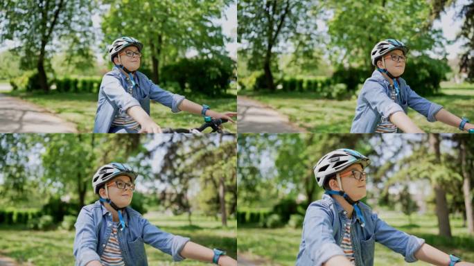 在阳光明媚的日子里，戴着护具的男孩在公园里骑自行车
