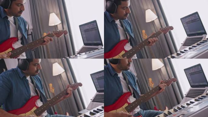 亚洲音乐家在家里的数码录音室录制电吉他。作曲家正在使用现代设备来创作旋律。