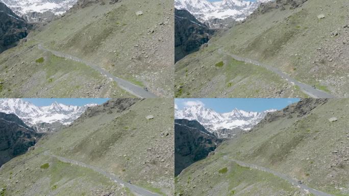 鸟瞰图，一个女人骑着自行车爬上了偏僻的山路