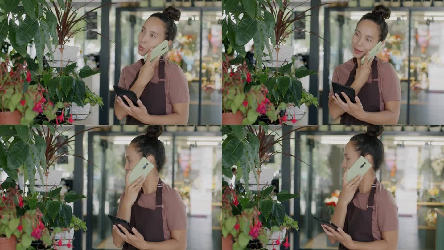 花店助理中东女士用手机和客户交谈，用平板电脑看绿色植物