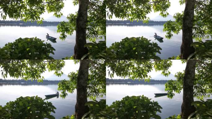 面目全非的湖上船夫操纵着他的木排船渡过湖面。树遮住了视野。模糊了