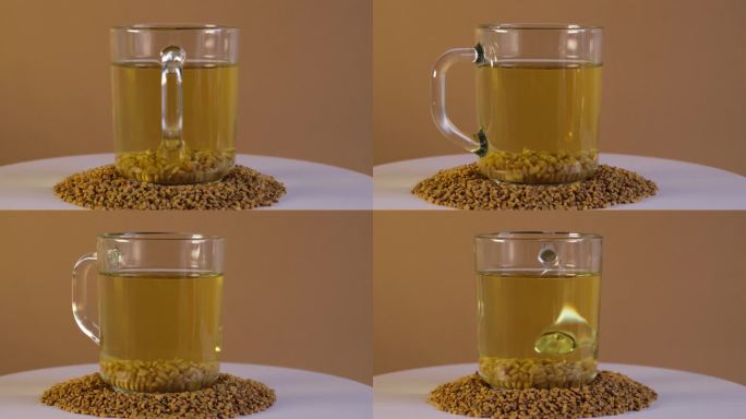 一杯埃及胡芦巴黄茶，Helba或Methi Dana饮料和胡芦巴种子在转盘上，侧面视图。4K视频，旋