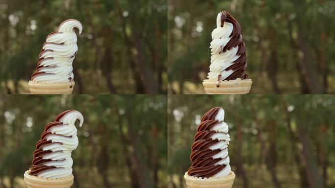 公园外，一位女士手里拿着两种不同口味的甜筒冰激凌。香草和巧克力的味道。享受夏日户外。4 k
