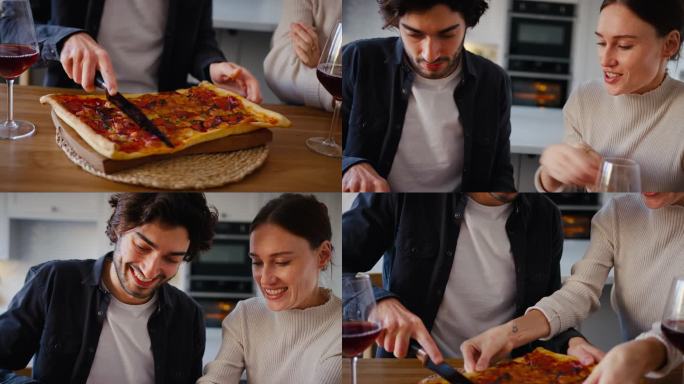 一对夫妇在厨房里从烤箱里拿出自制的新鲜披萨