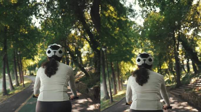 年轻女性在公园骑自行车。