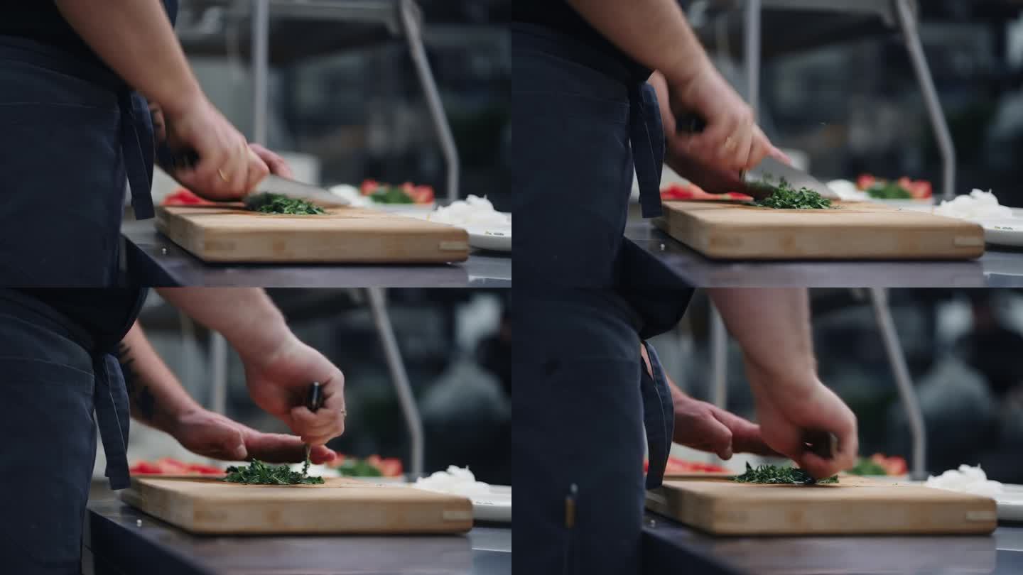 厨师切绿叶菜沙拉在餐厅厨房，男性的手特写
