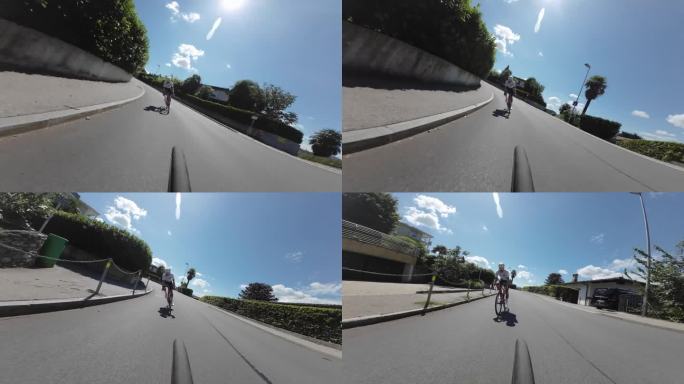 公路自行车骑手的低角度相机视图在自行车下行铺设山路