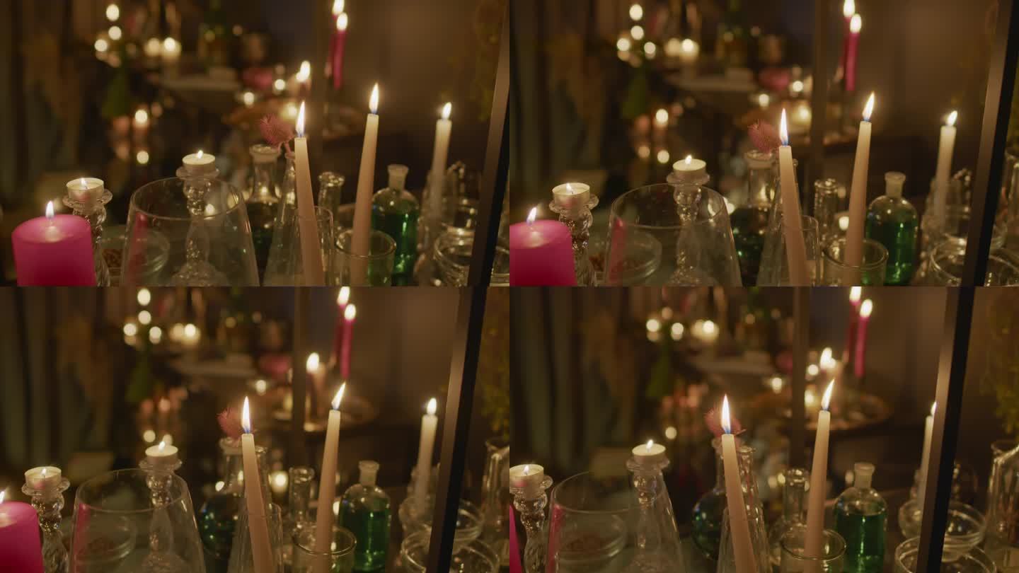 深色房间里燃烧的蜡烛和小瓶魔药
