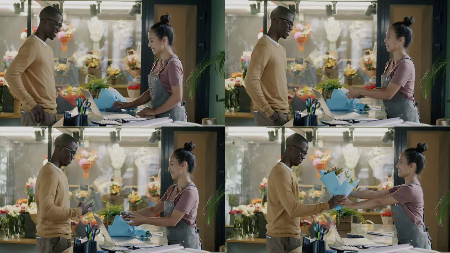 在一家现代商店里，一名非洲裔美国男子用智能手机买花并与售货员交谈