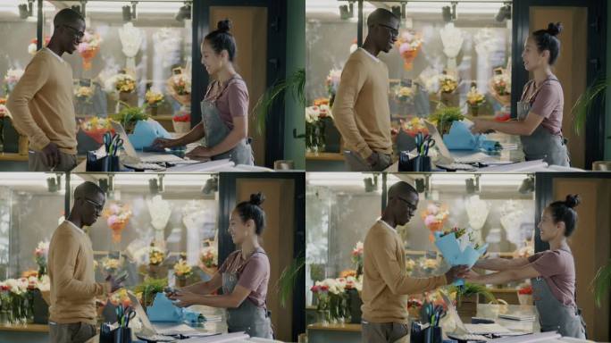 在一家现代商店里，一名非洲裔美国男子用智能手机买花并与售货员交谈