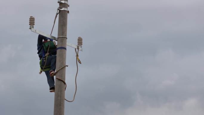 电力配网工人爬电线杆工作