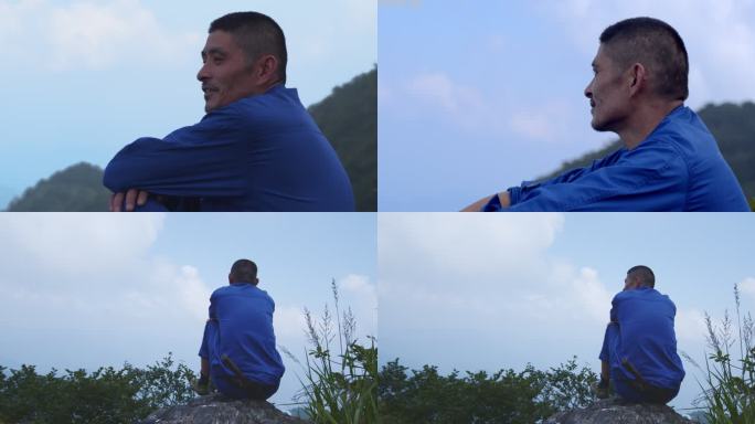 男子坐在山顶眺望