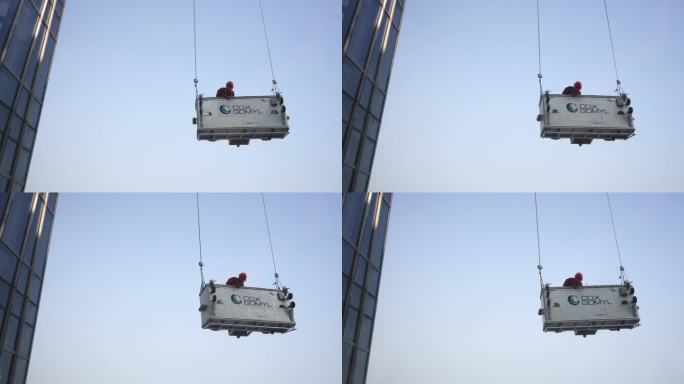 工程师在摩天大楼吊篮上工作