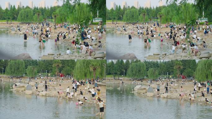 大面积沙滩人群小孩玩沙子城市绿化水系