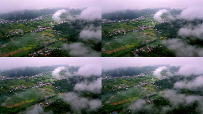桂林喀斯特地貌山间村庄和稻田上漂浮着薄雾