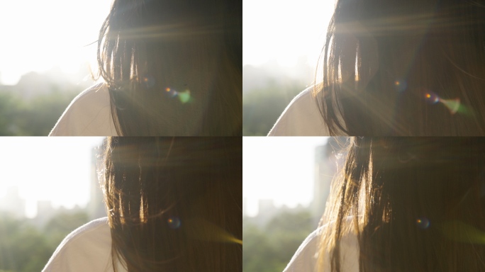 阳光下女孩看向远方微风吹动她的头发