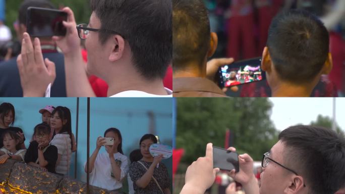 游客举起手机拍照特写