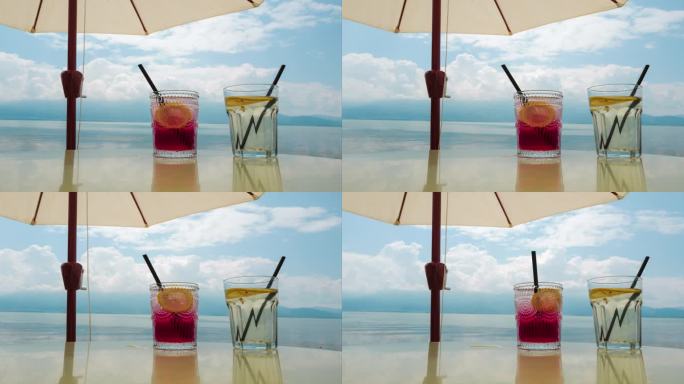 云南大理洱海边的天空、太阳伞与清凉饮料