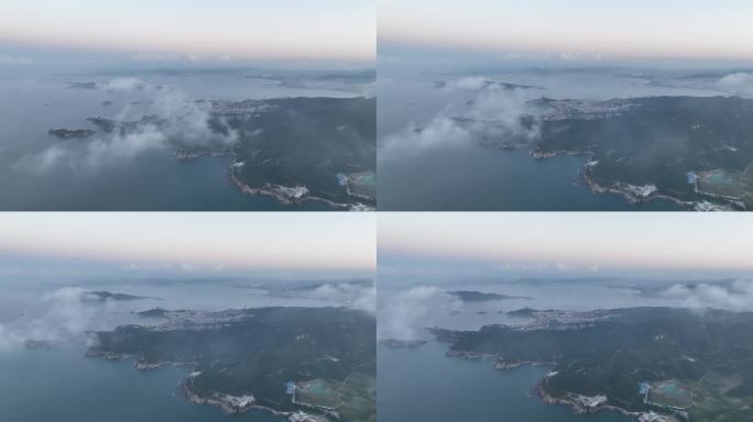 航拍俯瞰云雾之下的威海市环翠区环海路风光