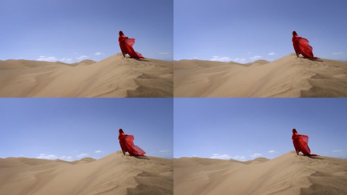 一个身穿红色长裙的女人站在沙漠中红裙