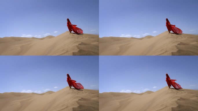 一个身穿红色长裙的女人站在沙漠中红裙