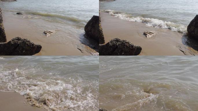 海边海浪沙滩浪花拍在沙滩上