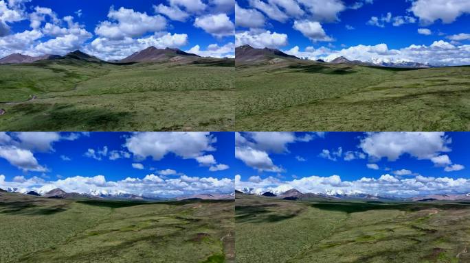 山峦雪山蓝天白云草地航拍