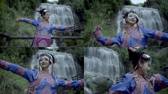 彝族女生在瀑布下跳舞