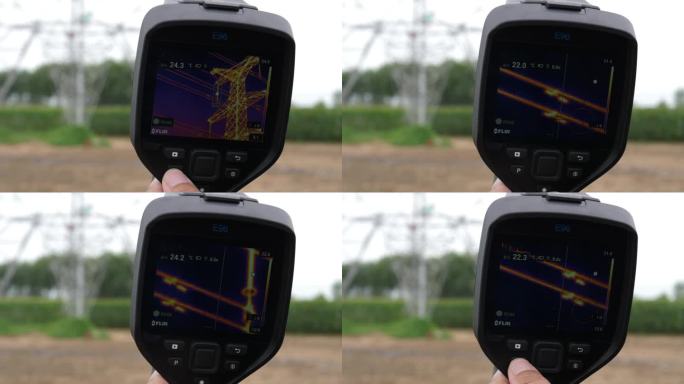 国家电网工人用热像仪检查高压线