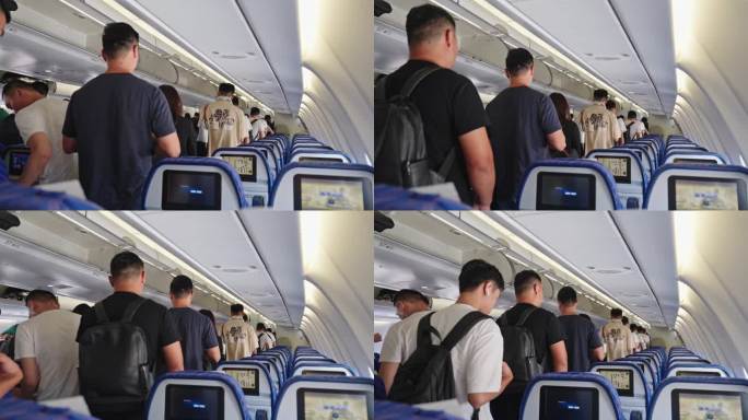 飞机上乘客携带行李排队下飞机