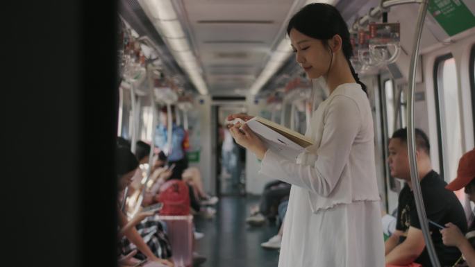 地铁里看书女生