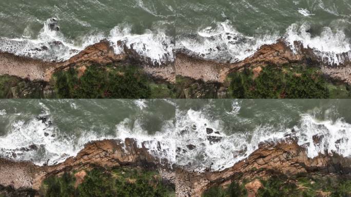 航拍威海国际海水浴场波涛汹涌的礁石海浪