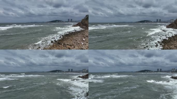 航拍威海国际海水浴场波涛汹涌的礁石海浪