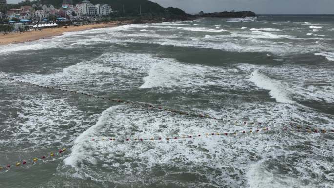 航拍威海国际海水浴场波涛汹涌的礁石海浪