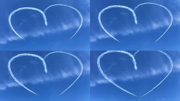两架飞机在蓝天白云的空中飞行划出浪漫心型