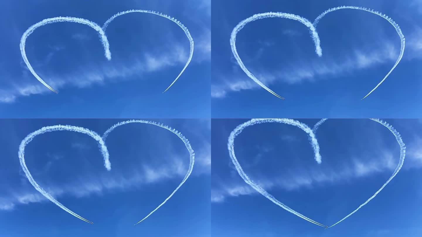 两架飞机在蓝天白云的空中飞行划出浪漫心型