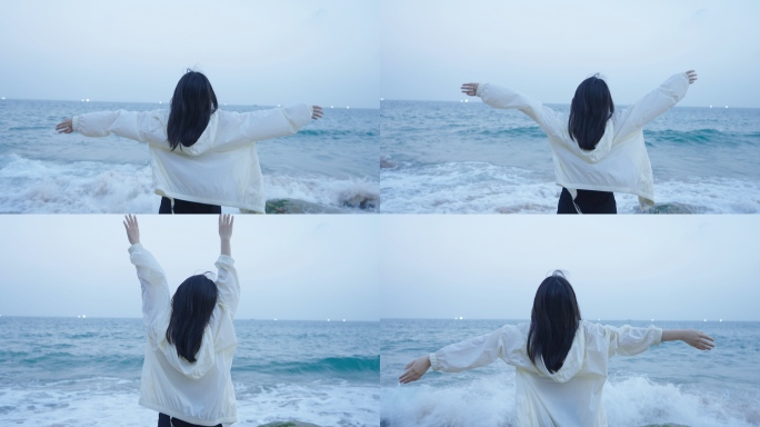 女孩展开双手拥抱大海感受自由和风