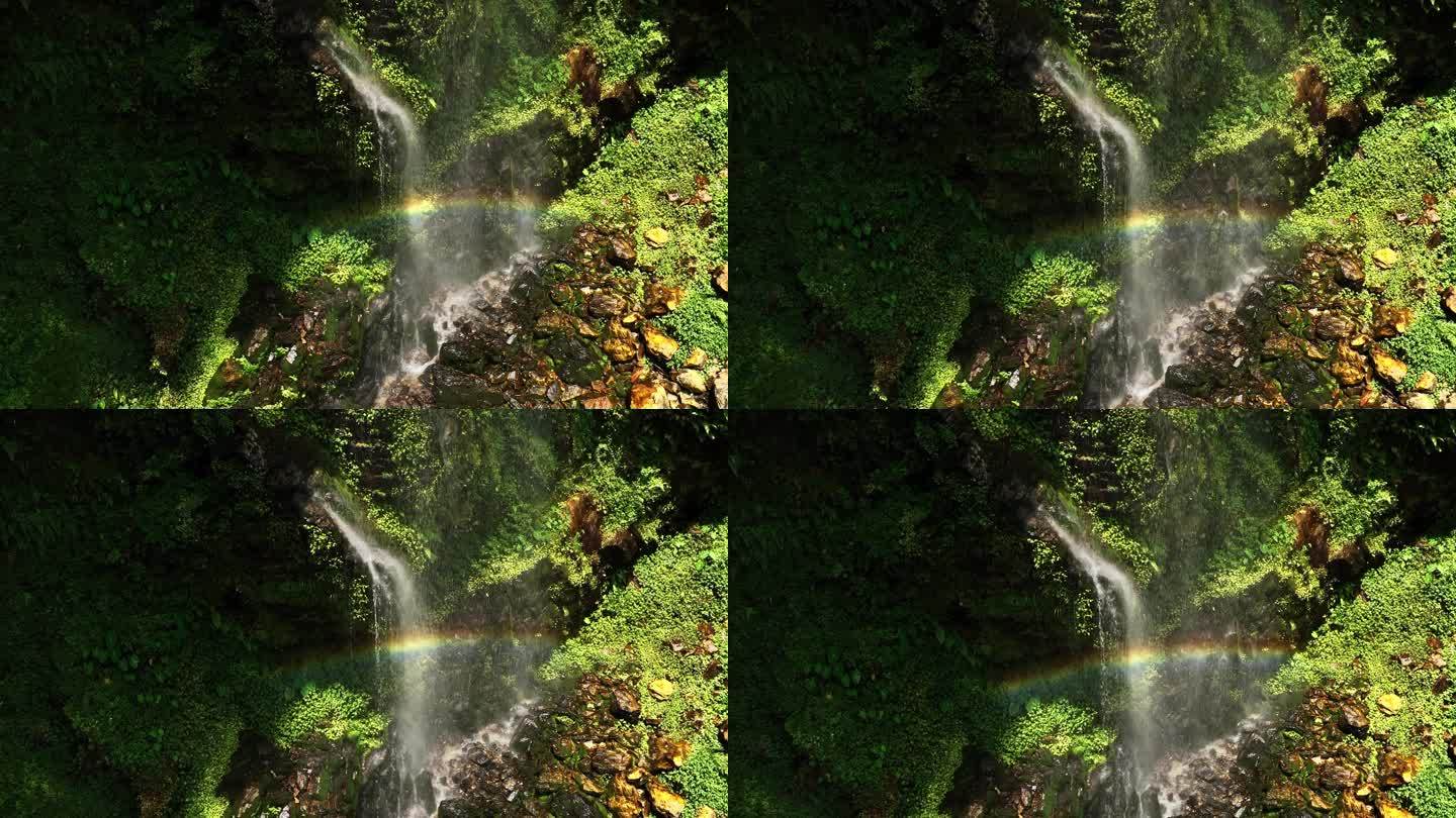 慢镜头航拍桂林山区峡谷中森林瀑布上的彩虹