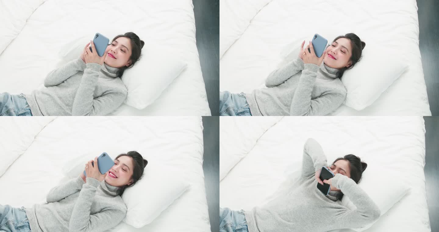 美女躺在床上玩手机微笑