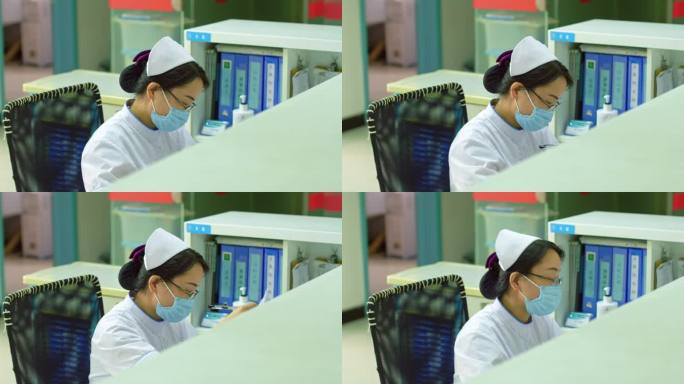 护士站的护士在l电脑上病患输入信息