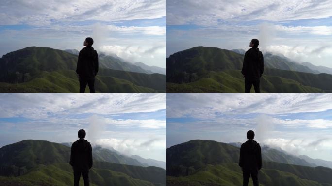 美女站在山顶看风景背影看远山风景感受自然