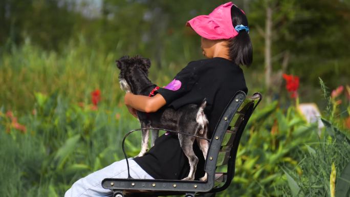 坐椅子上抱小狗的女孩