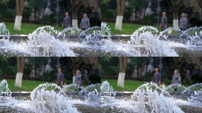 幸福社区祖孙三人走过水景喷泉