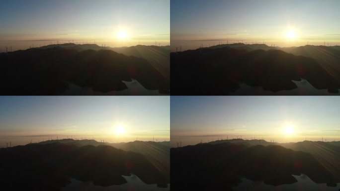 航拍桂林天湖群山间电力风车上的日出