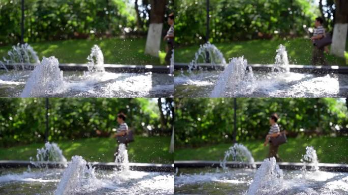 幸福生活上班的中年女性走过水景喷泉
