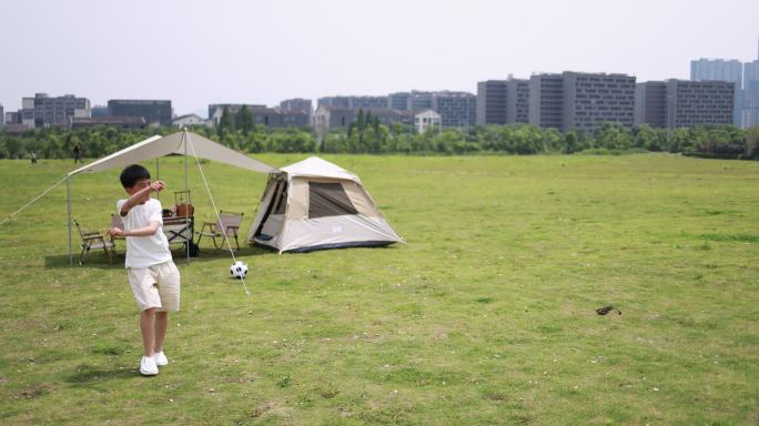 年轻家庭户外露营，父子玩飞盘慢镜头