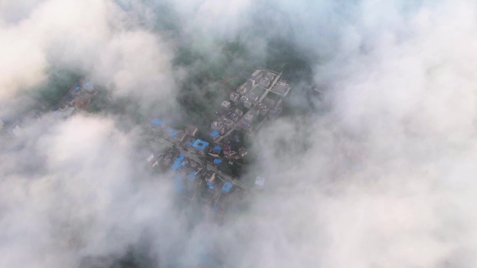 高空航拍俯瞰云雾中的现代城市建筑群