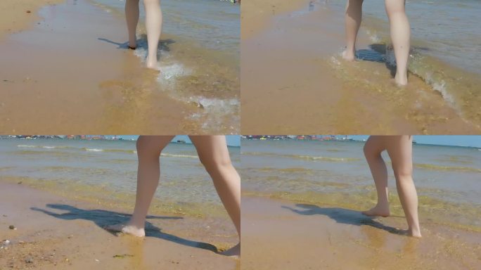 女人赤脚在海滩上行走
