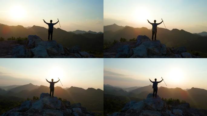 一个人站在山顶张开双臂拥抱梦想希望向自由