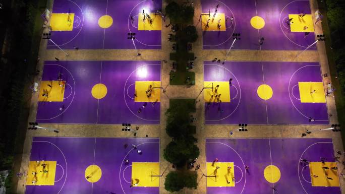 航拍城市夜晚灯光篮球场上运动健身人群